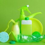 Monochrome green bottles and containers for liquids or gel with plastic bottle and lids on green background